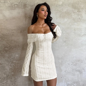 Close-up of white lace bodycon dress with off-the-shoulder neckline and drawstring detail