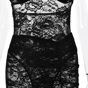 Detailed macro view of black floral lace fabric on the waist and abdomen of the bodysuit