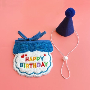 Detail view of blue pet birthday hat and embroidered bib with adjustable elastic straps