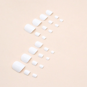 Glossy milky white press-on toenails set 24pcs in various sizes on beige background