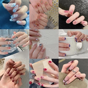 Collage of nine stylish press-on nails featuring blue flame, pink heart, and floral designs