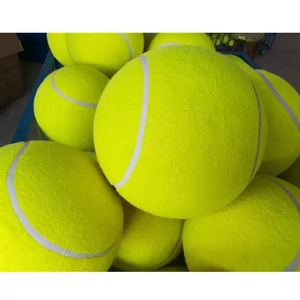 Close-up of oversized yellow felt tennis balls showing fuzzy texture and white seam lines