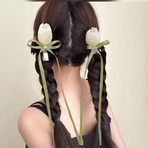 Korean style tulip hair clips with ribbons on model double braids in soft light