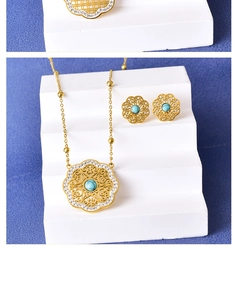Detailed shot of vintage gold flower jewelry set with turquoise stones and crystals