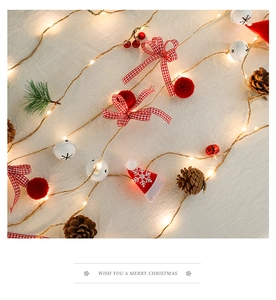 Detail of Christmas LED string lights with pine cones, red berries and stars