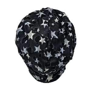 Detailed close-up of distressed knit beanie with white stars and street style ripped effects