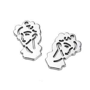 Detail view of silver alloy abstract face silhouette charms for DIY jewelry making