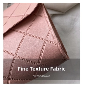 Detail of pink quilted leather bag showing fine texture fabric and elegant stitching