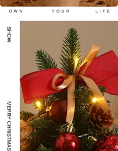Close-up of mini Christmas tree with red burlap bows, pine cones and warm LED lights