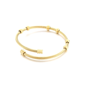 Gold twisted wire cuff bracelet featuring six smooth beads and an adjustable open design