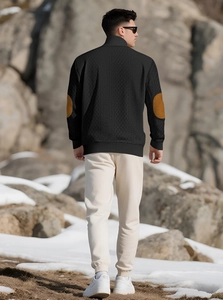 Detail of black long-sleeve knit sweater with brown leather elbow patches on the sleeves