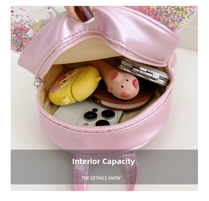 Internal capacity of pink sequin girl's backpack showing smartphone and accessories