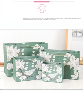 Detailed set of four green paper gift bags featuring white floral and bird patterns