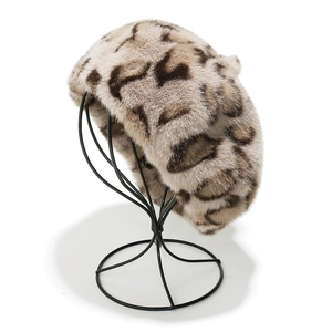 Close-up of fluffy leopard print faux mink fur beret showing plush texture and pattern
