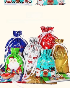 Assorted Christmas drawstring gift bags featuring festive Santa and reindeer patterns