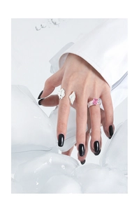 Detail of S925 sterling silver rings with pink square gemstone on model hand with ice cubes