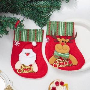Red Christmas stockings with Santa and Reindeer designs for holiday tree decoration