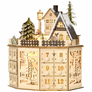 Detail of wooden advent calendar with 12 numbered drawers and glowing LED village scene