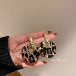 Acrylic leopard print hoop earrings with textured gold metal cap and round resin design