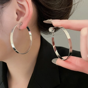 Detail view of silver round hoop clip-on earrings with adjustable screw closure