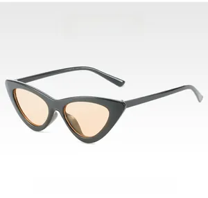 Detail view of vintage cat eye sunglasses with thick black frames and champagne lenses