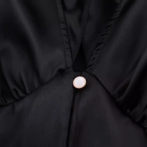 Women's elegant V-neck black satin mini dress with decorative gold-edged pearl button