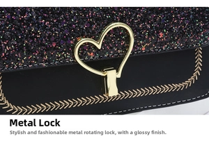 Close-up of golden heart-shaped twist lock and black glitter fabric on handbag
