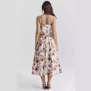 Floral A-line midi dress with red and yellow roses and open back spaghetti straps