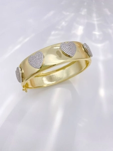 Detailed side view of a gold-plated bracelet featuring zircon-encrusted heart charms