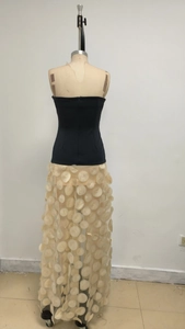 Detail of elegant black tube top dress with beige 3D floral petal appliques on sheer skirt