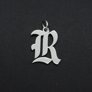Detailed macro view of a silver Gothic letter R pendant in stainless steel for DIY jewelry