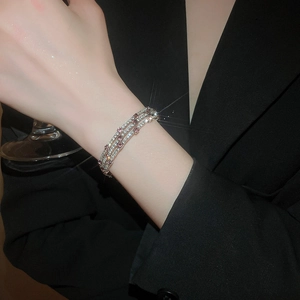 Detail of three-layer zircon bracelet featuring pink stones and sparkling micro-inlay