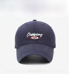 Detail view of navy blue baseball cap with Champions ATH 1989 letter embroidery