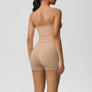Rear view of nude sports bra with criss-cross back straps and high-waist fitness shorts