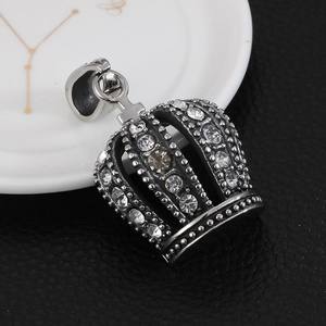 Macro shot of silver crown pendant featuring clear rhinestones and vintage finish