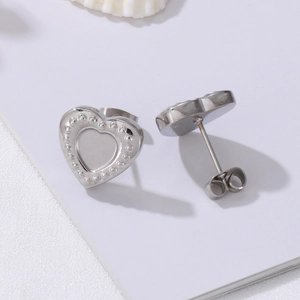 Polished silver heart stud earrings with beaded edge detail in stainless steel material