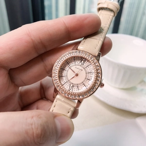 Women's quartz watch with crystal rose gold case and beige leather strap shown in hand