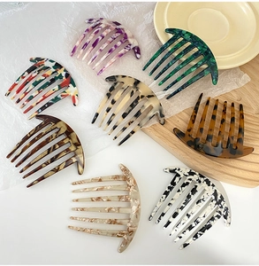 Detail shot of multi-color acetate hair side combs in classic amber and marble textures