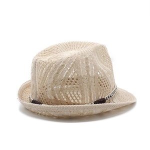 Detail of breathable hollow mesh weave and brown decorative cord on beige sun hat