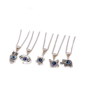 Set of 5 silver necklaces with owl butterfly elephant evil eye charms on white background
