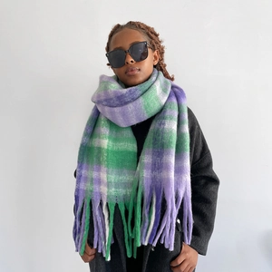 Detail of purple and green gradient mohair scarf featuring long tassels and soft texture