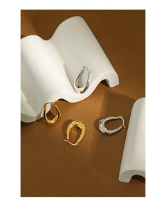 Close-up of minimalist U-shaped S925 sterling silver hoop earrings in gold and silver finish