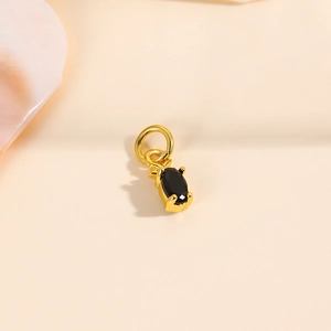 Close-up of 18k gold plated pineapple pendant with black oval zircon for DIY jewelry