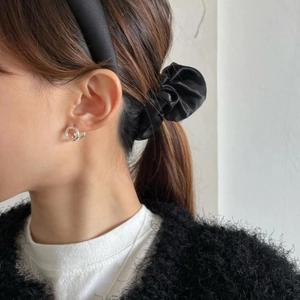 Minimalist S925 sterling silver spiral twist hoop earrings worn by a model in casual style