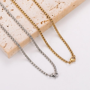 Gold and silver 18k plated portrait pendant necklaces on a textured stone display