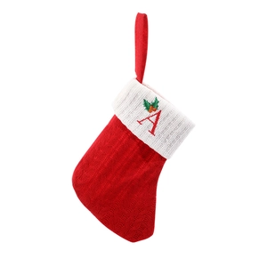 Red knitted Christmas stocking with white cuff and embroidered letter A for holiday decor