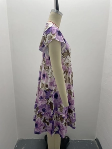 Detail of purple floral dress with tiered skirt and ruffled cap sleeves on mannequin