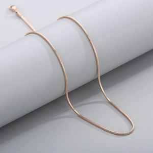Detail of rose gold snake bone chain showing its smooth texture and metallic luster