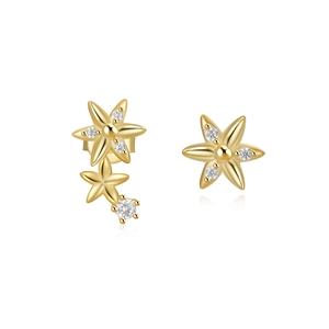 Macro detail of asymmetric 925 silver flower stud earrings with gold finish and zircon stones