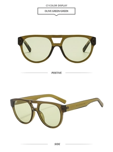 Detail of olive green double bridge sunglasses with transparent frame and flat lenses